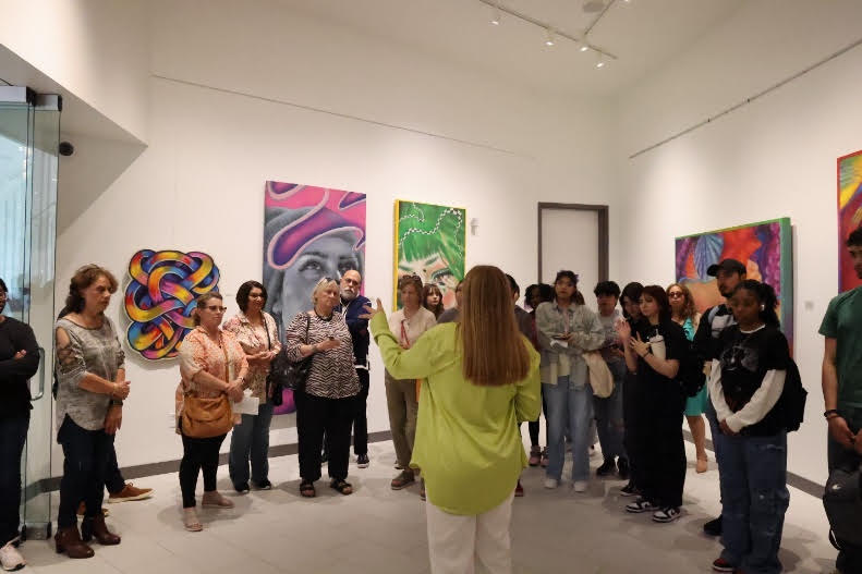 Lone Star College-University Park graduate, and professional artist Taylor Barnes discusses her artwork during the “Taylord: Anemoia” opening reception on Feb. 26, 2024.   