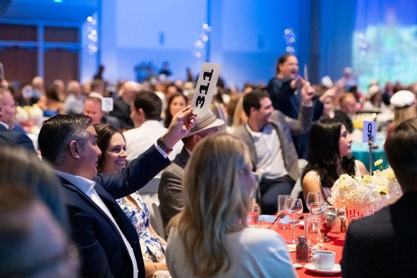 Attendees at the 2024 Fighting Hunger, Feeding Hope Gala took part in a spirited live auction to support the Food  Bank. 