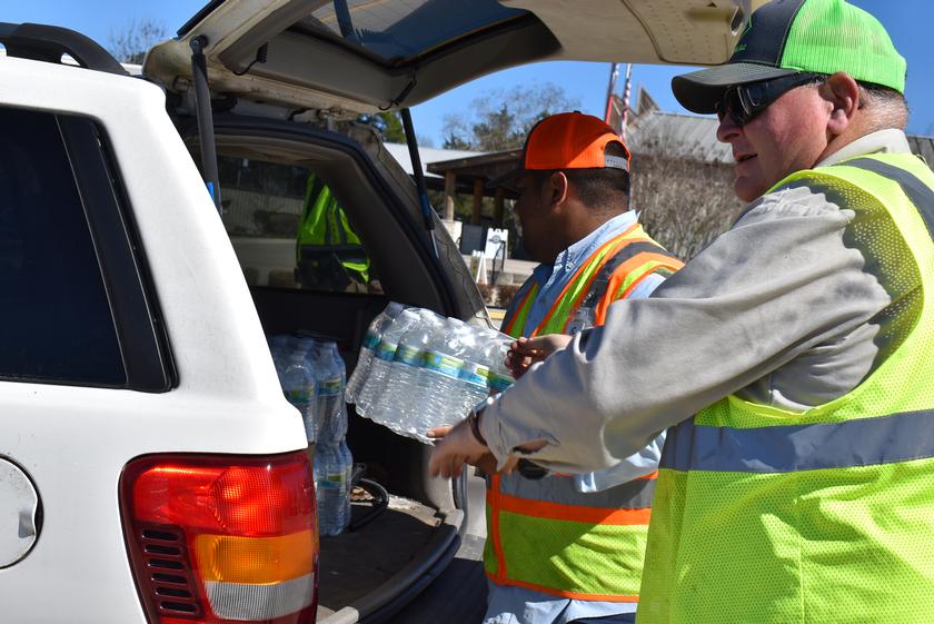 Montgomery County Food Bank volunteers load water into the car of individuals affected by the storm. 