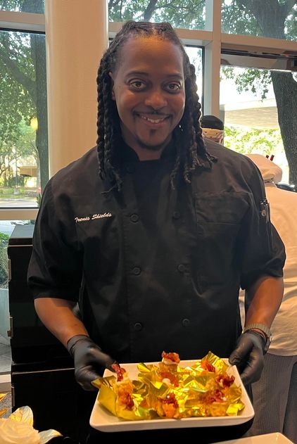 Chef Trenis Shields of Mary Thorn’s ‘Thistle Drafthouse’ displays his masterpiece, ‘Black Garlic Herb Biscuit w/Bree Crema, topped with red pepper and orange marmalade’ 