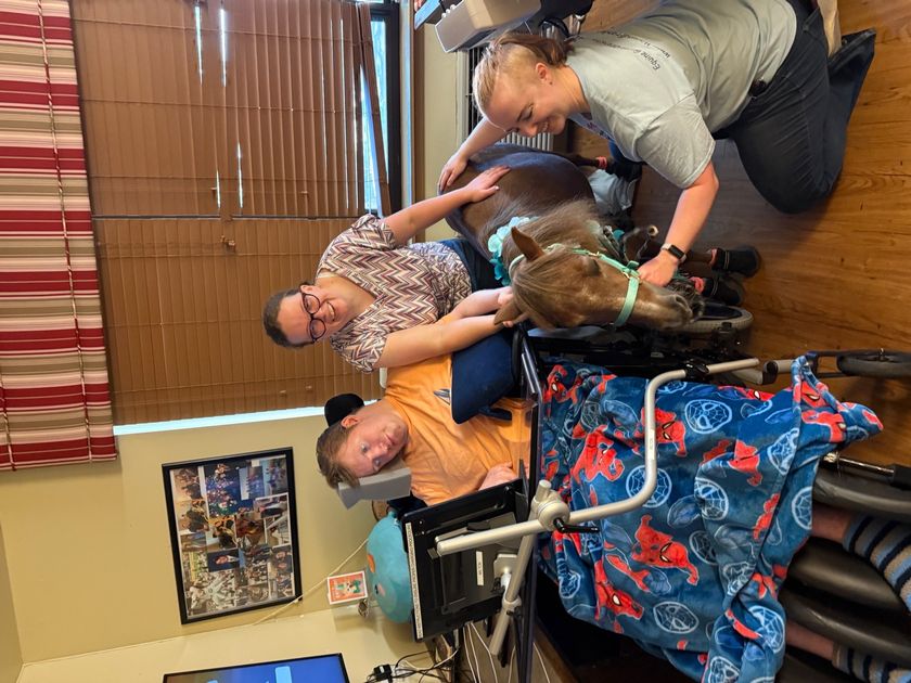 Grant in August 2025 with his care team at Marbridge near Austin, TX