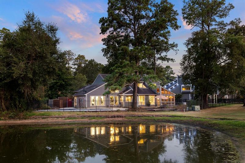 Dream waterfront home nestled on the 7th green/8th tee box of the prestigious Woodlands Country Club